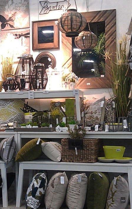 A mix of home accessories that incorporate green and grey.