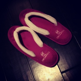 Plush complimentary slippers in our hotel room.