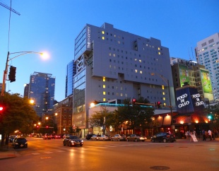 The exterior of The Godfrey Hotel at night.